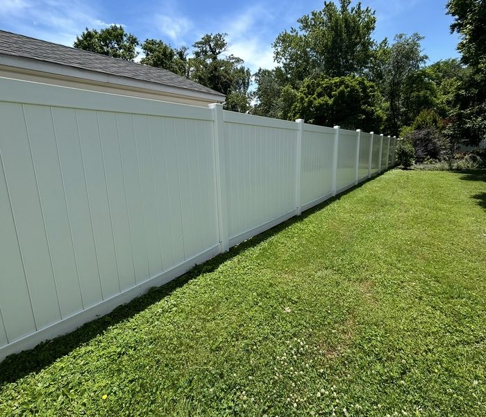 The same vinyl fence clean and white after washing